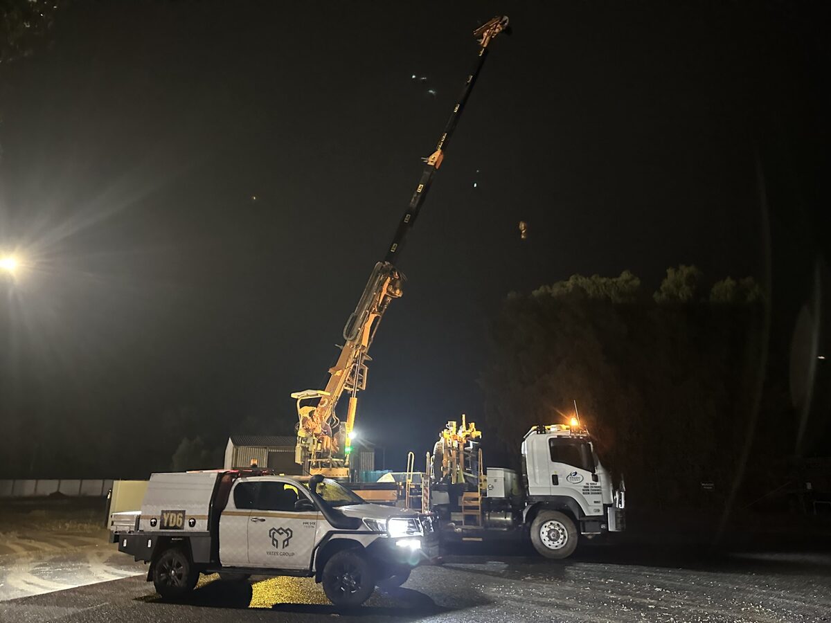 Crane truck working under lights at night