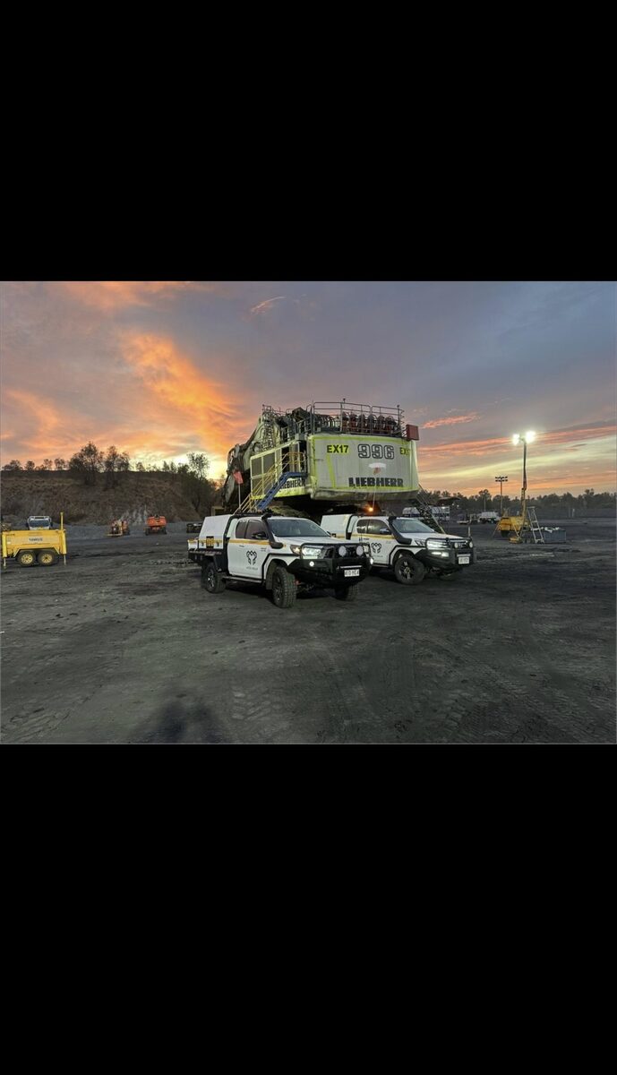 Liebherr excavator at dusk with Yates Group vehicles on site