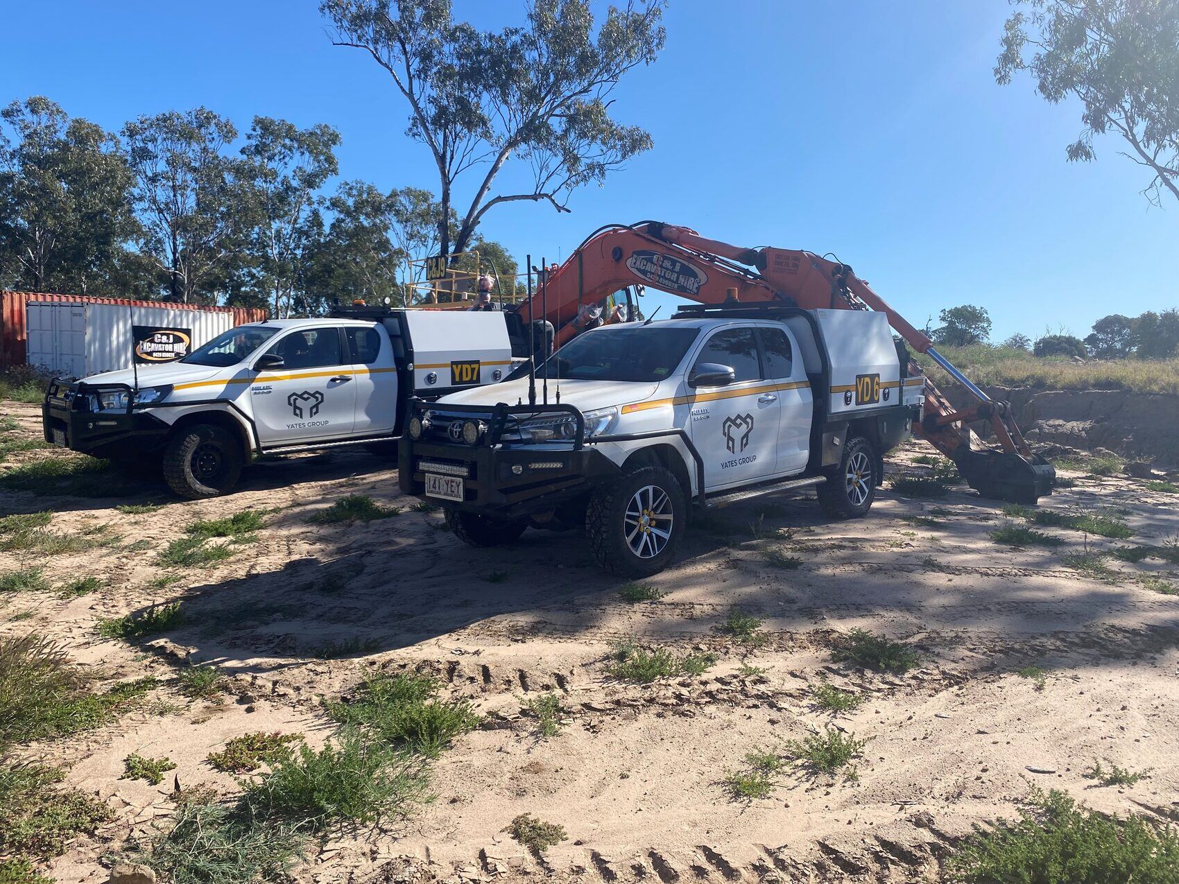 Yates Group utes on site with an excavator behind