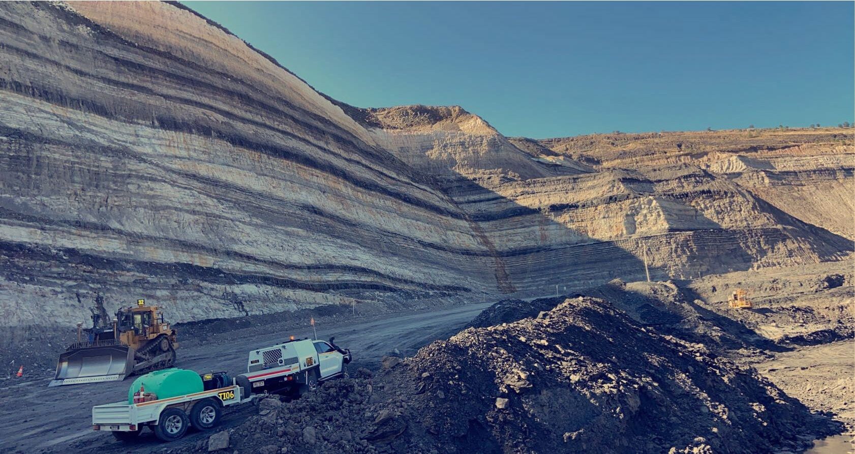 Yates Group ute on a mine bench below a highwall at Minerva Mine