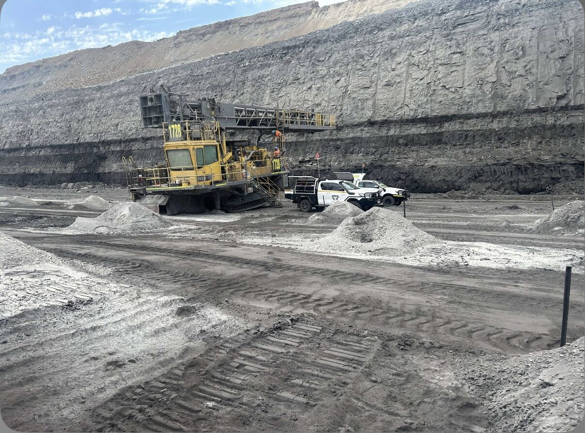 Yates Group ute beside a large mining shovel on a bench