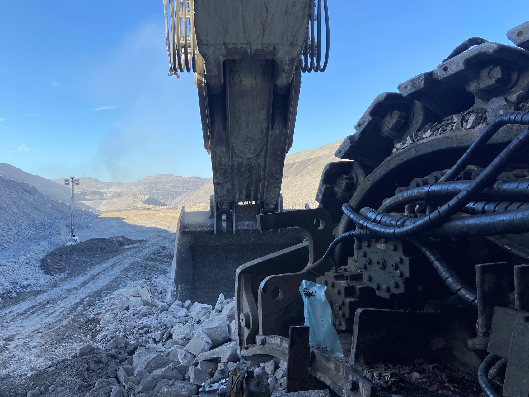 Large hydraulic excavator working in a mine pit, supported by Yates Group